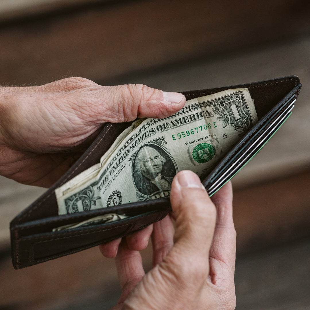 Stylish and sturdy dark oak billfold wallet made from high-quality leather with an embossed logo detail.