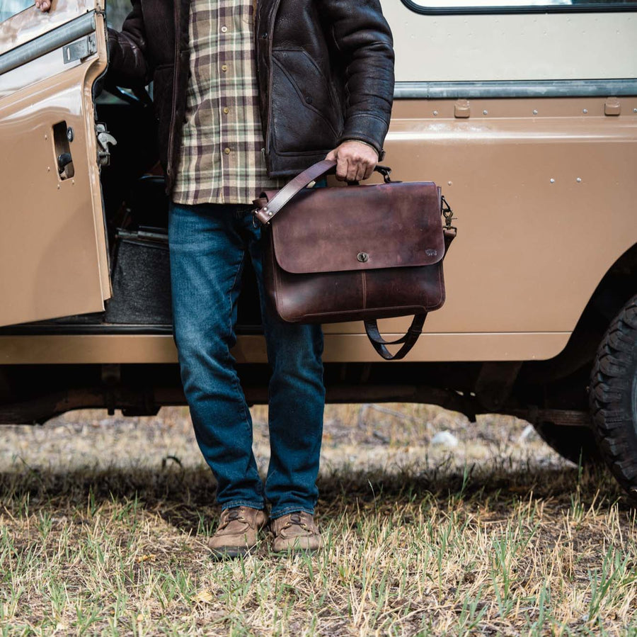 Roosevelt Full-Grain Leather Laptop Messenger Bag in Dark Oak — antique brass turn-lock clasp, adjustable strap, front angle