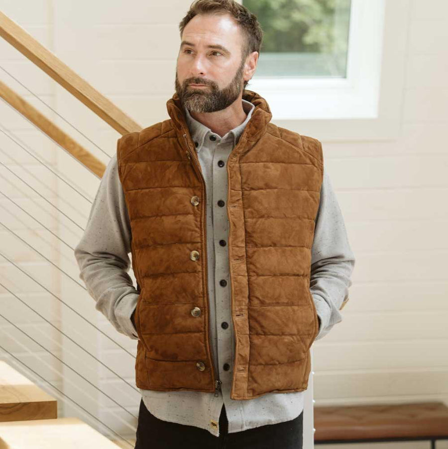 A brown suede leather vest with quilted patterns and a mandarin collar, featuring button closures and two front pockets.